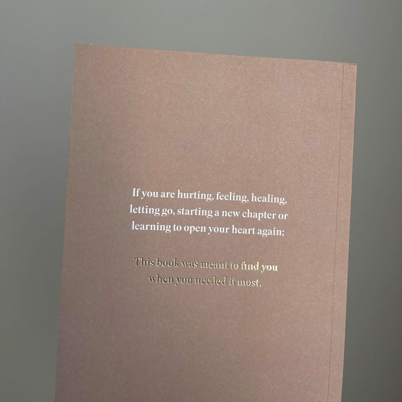 A brown notebook with the quote "This Was Meant To Find You (When You Needed It Most)" by Thought Catalog.