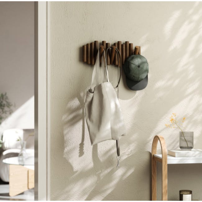 Umbra Picket wall hook holding coats and bags