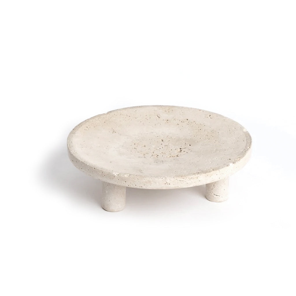 Nome round travertine stand in Light Travertine on short rounded feet, on a white background
