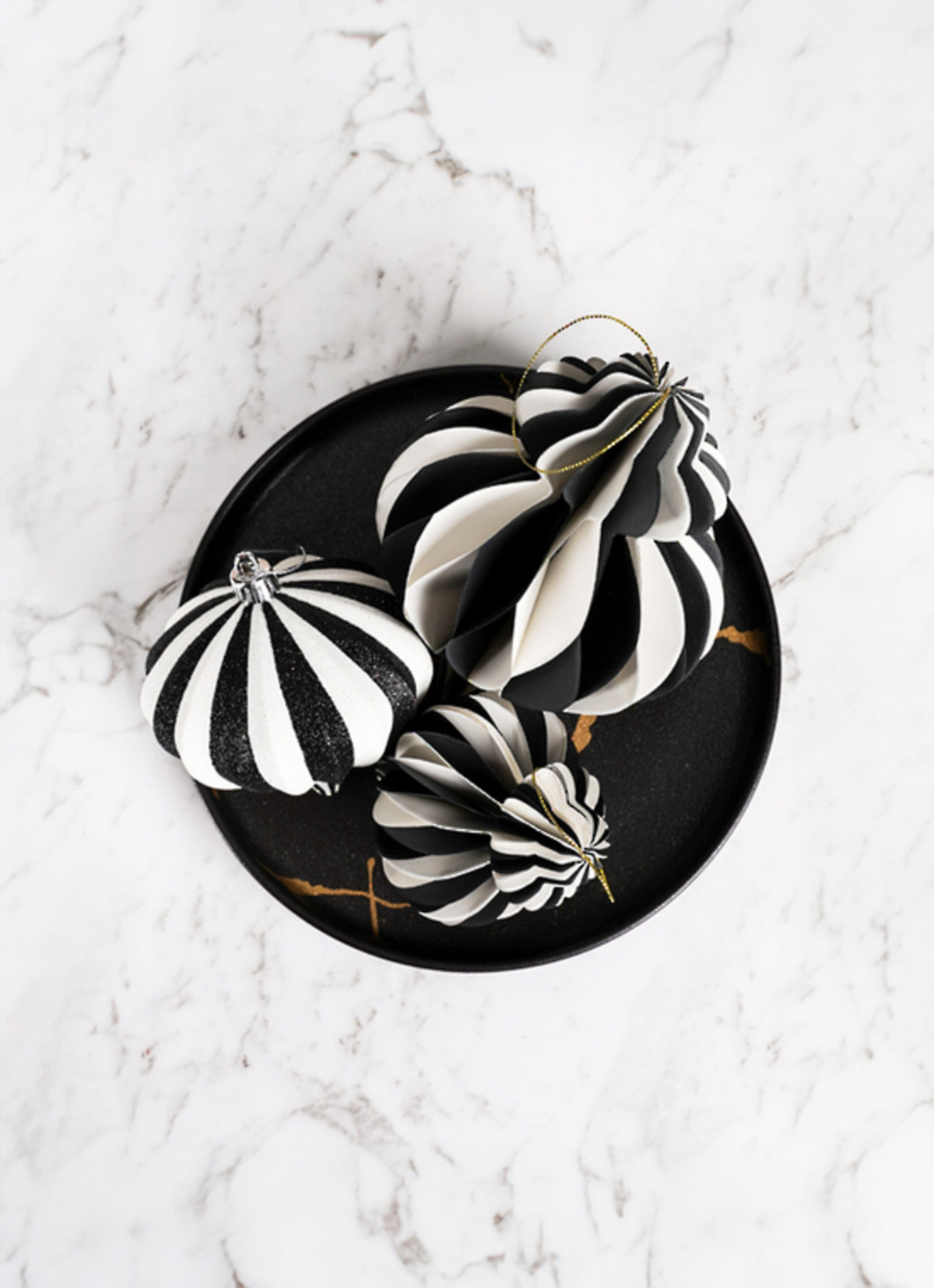 Monochrome paper finial decoration styled with other paper decorations