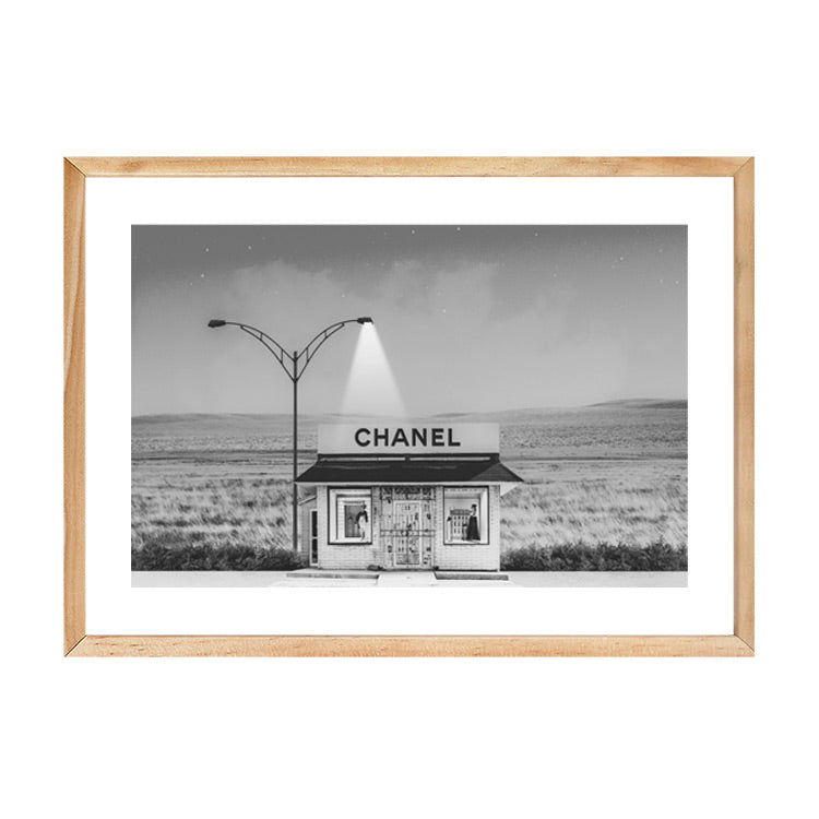 Chanel Shop black and white print in a natural wood frame