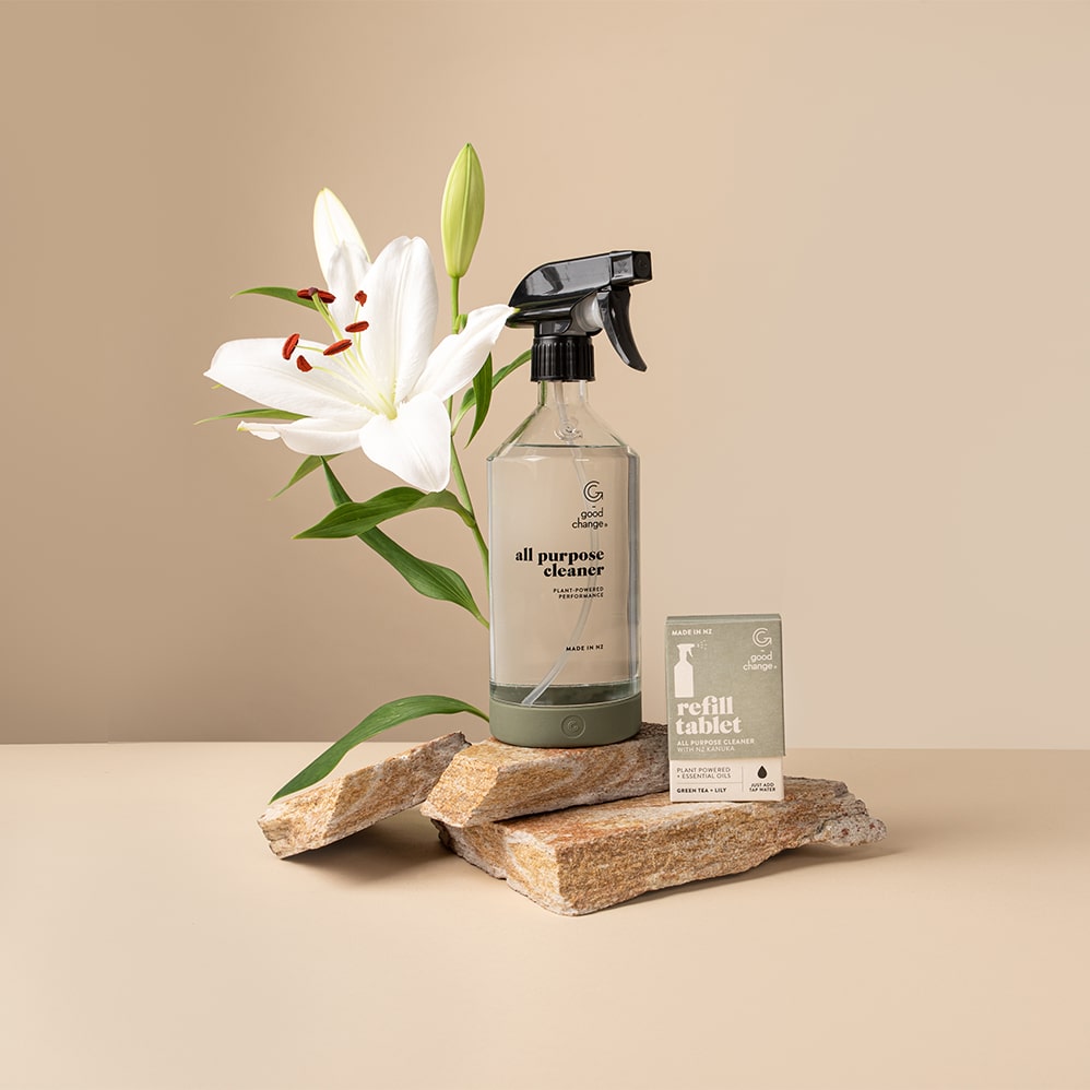 All-purpose reusable glass spray bottle with silicone base on a benchtop