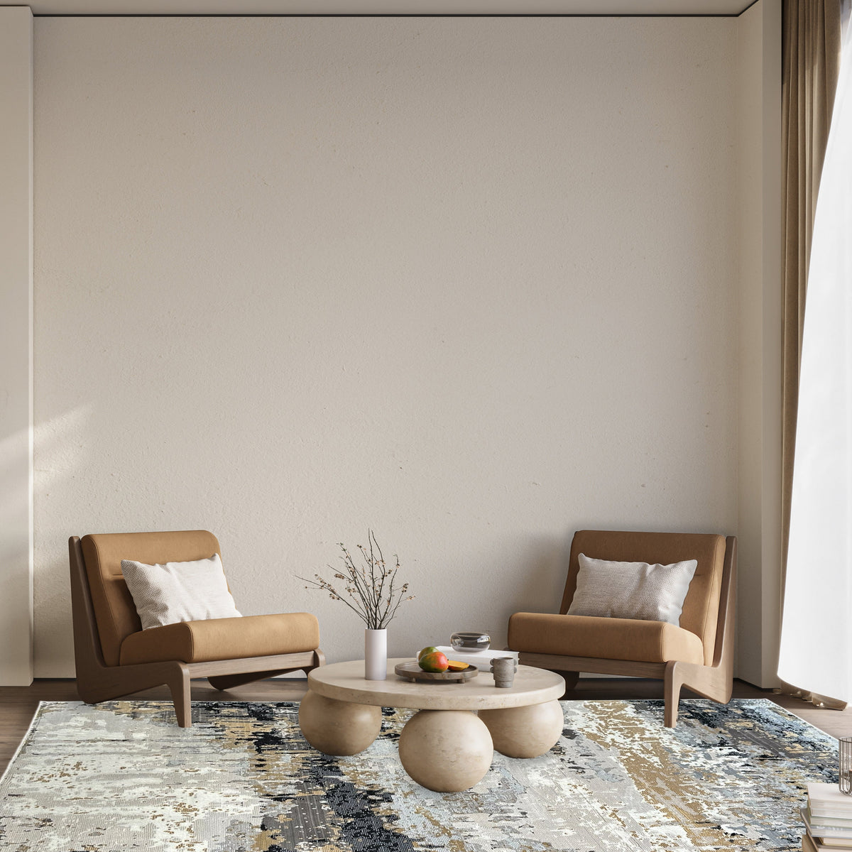 Abstract gold and grey rug under a pale round coffee table between two tan lounge chairs