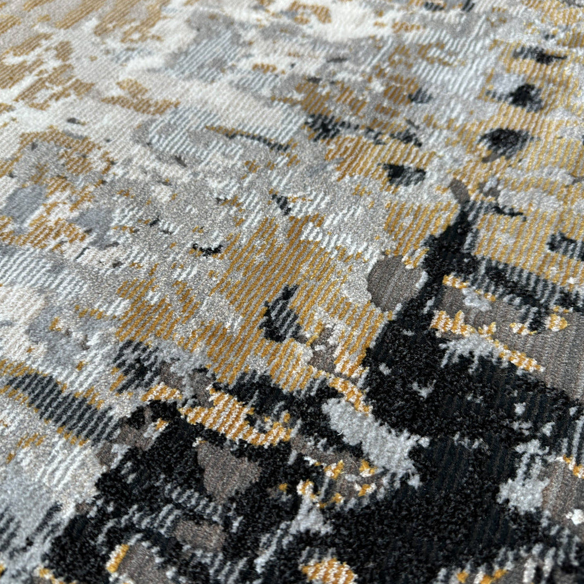 Close view of the low pile with patches of black, grey and gold