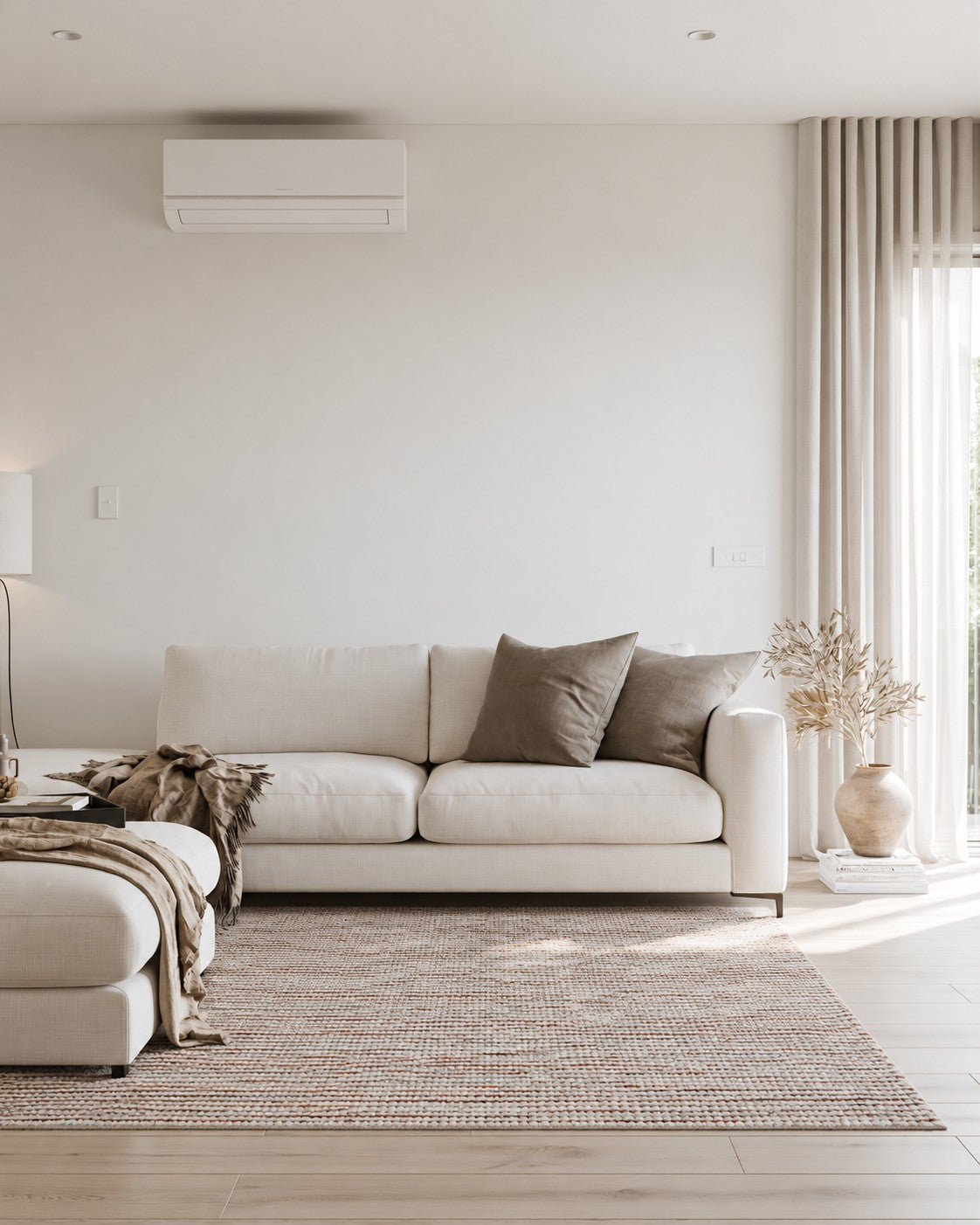 Aragon Wool Rust Rug styled in a bright lounge beneath a white sofa