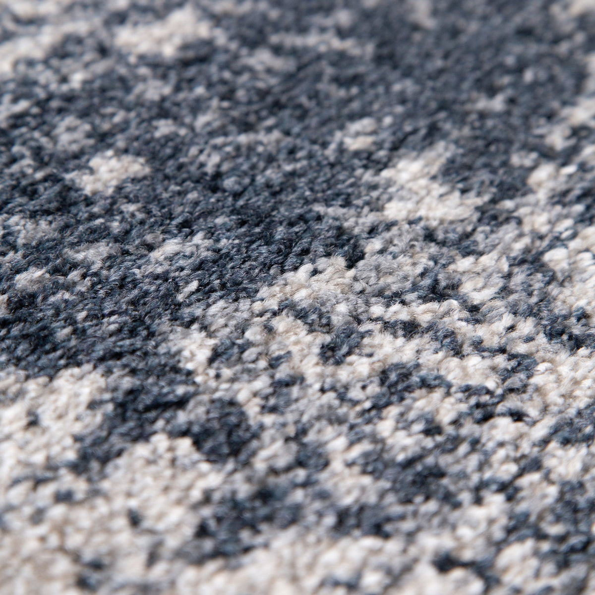 Close view of the soft pile with dark blue patches over cream