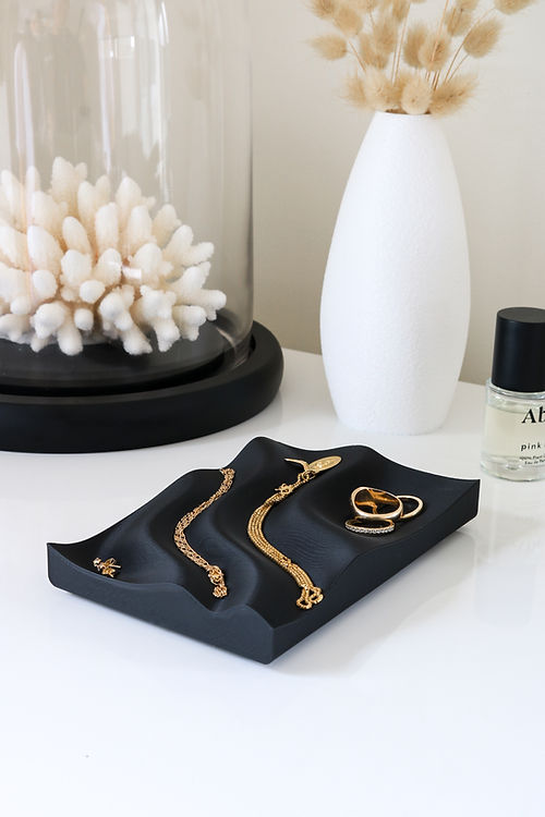 A Utilize Studios Tidal Tray showcasing gold jewelry, 3D printed using recycled plastic.