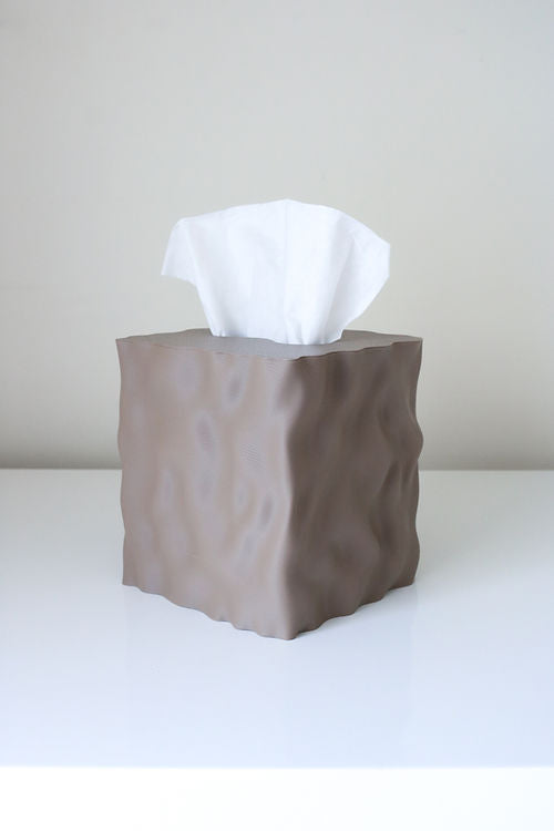 Flow tissue box cover in a warm brown matte finish on a white table