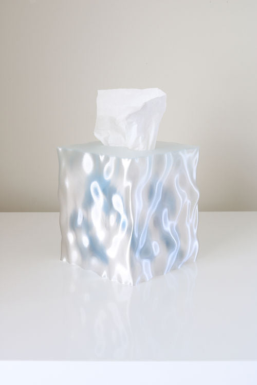 Clear Flow tissue box cover on a white shelf against a pale grey wall