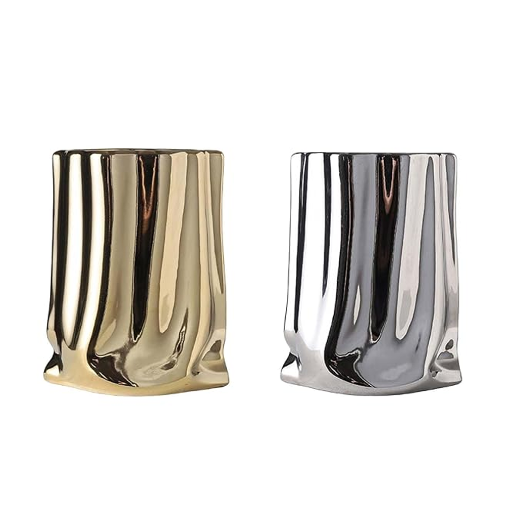 Gold and silver metallic bag vases side by side on a plain background