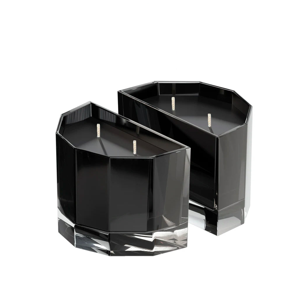 Two half-moon Blend soy candles in faceted black glass fitted together, on a white background