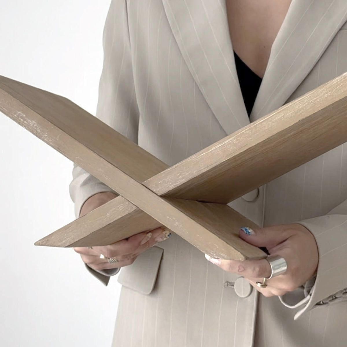 Natural Como book stand held open to show its folding cross frame