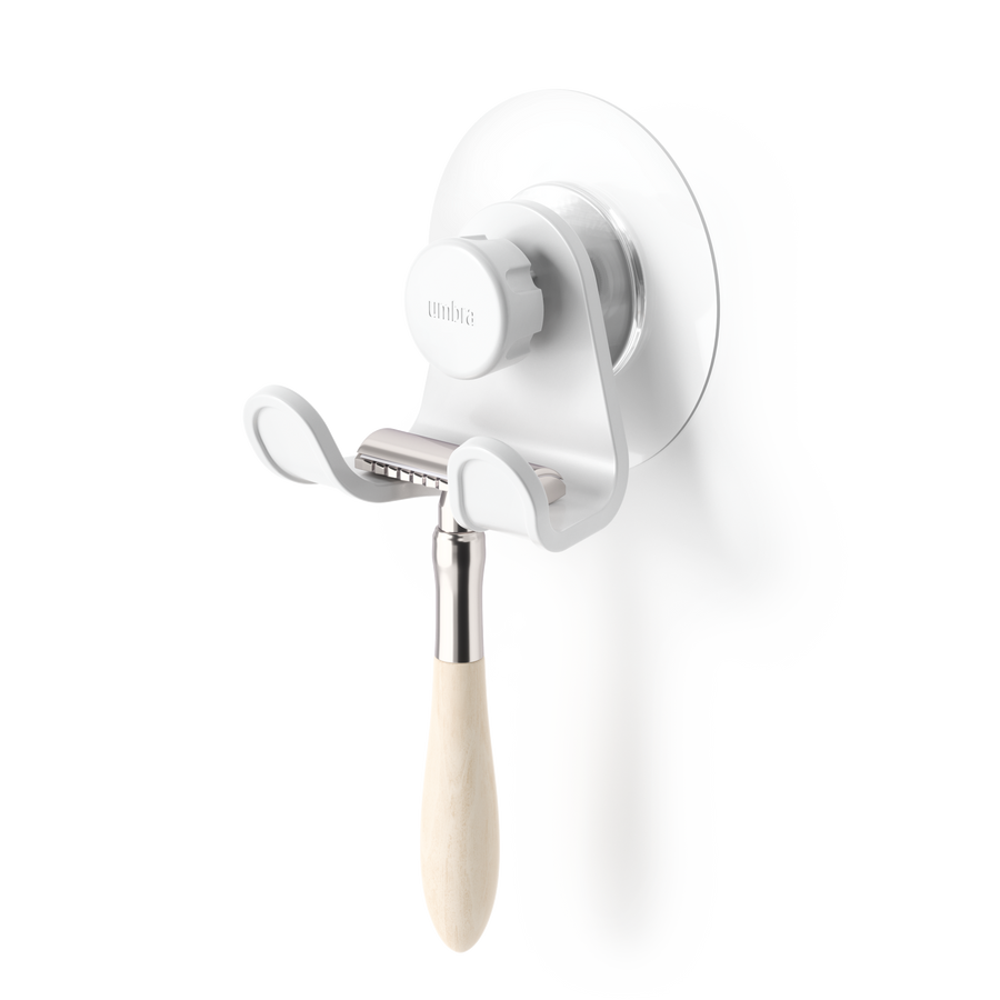 Umbra Flex adhesive double hook in white holding a razor in a bathroom