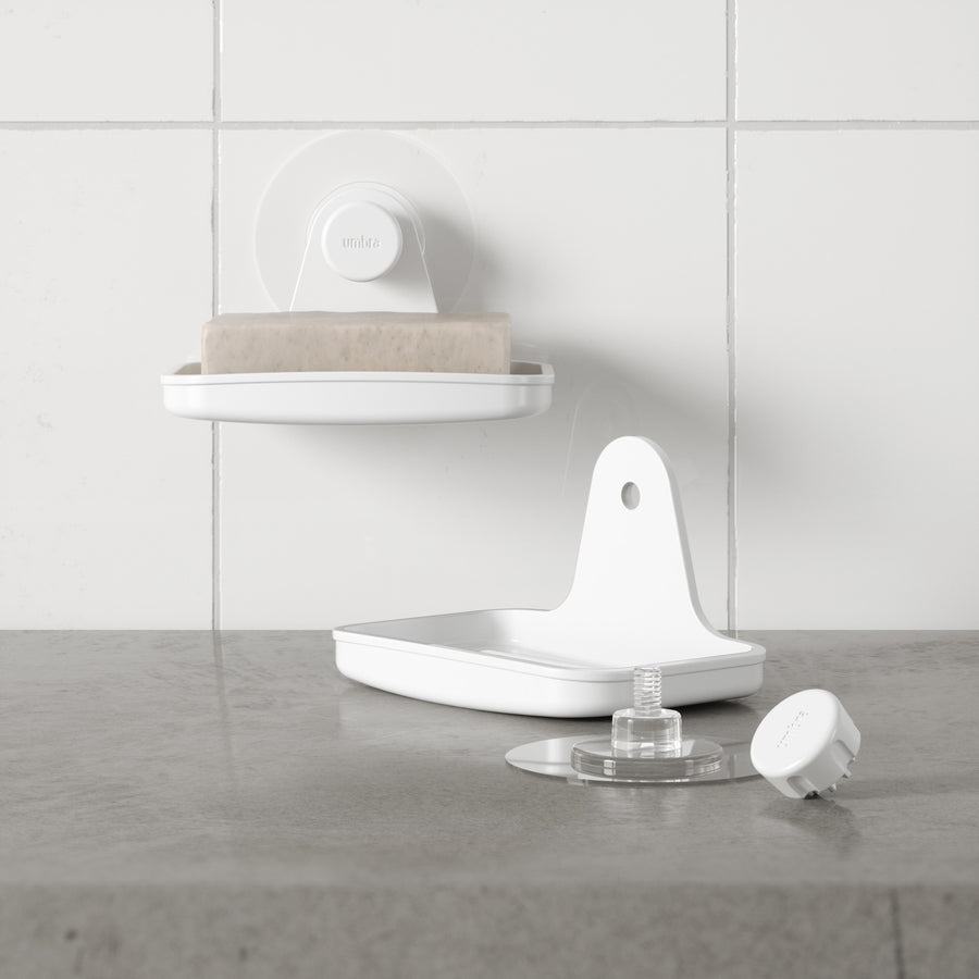 Umbra Flex adhesive soap dish in white on a tiled wall with a second dish below