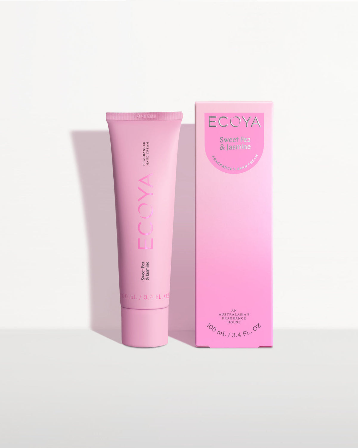 Ecoya hand cream in a pink tube beside its pink gradient box