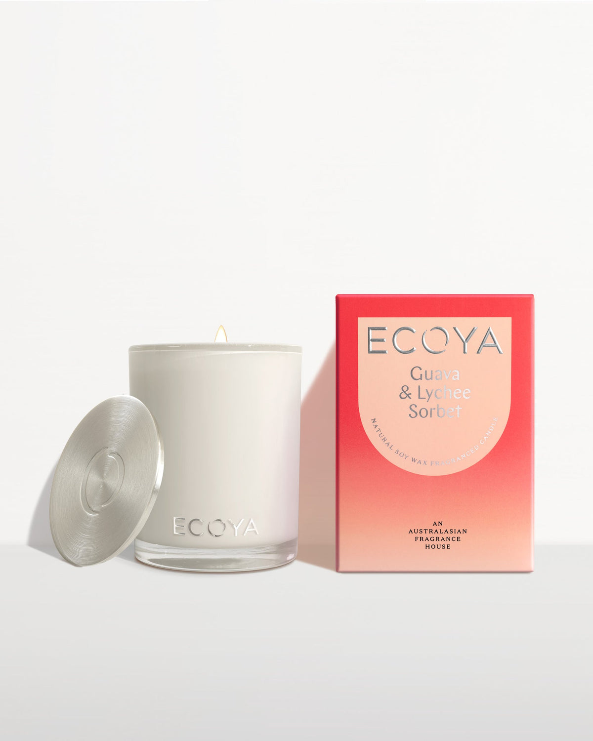 Ecoya Madison candle with the lid off beside its red gift box