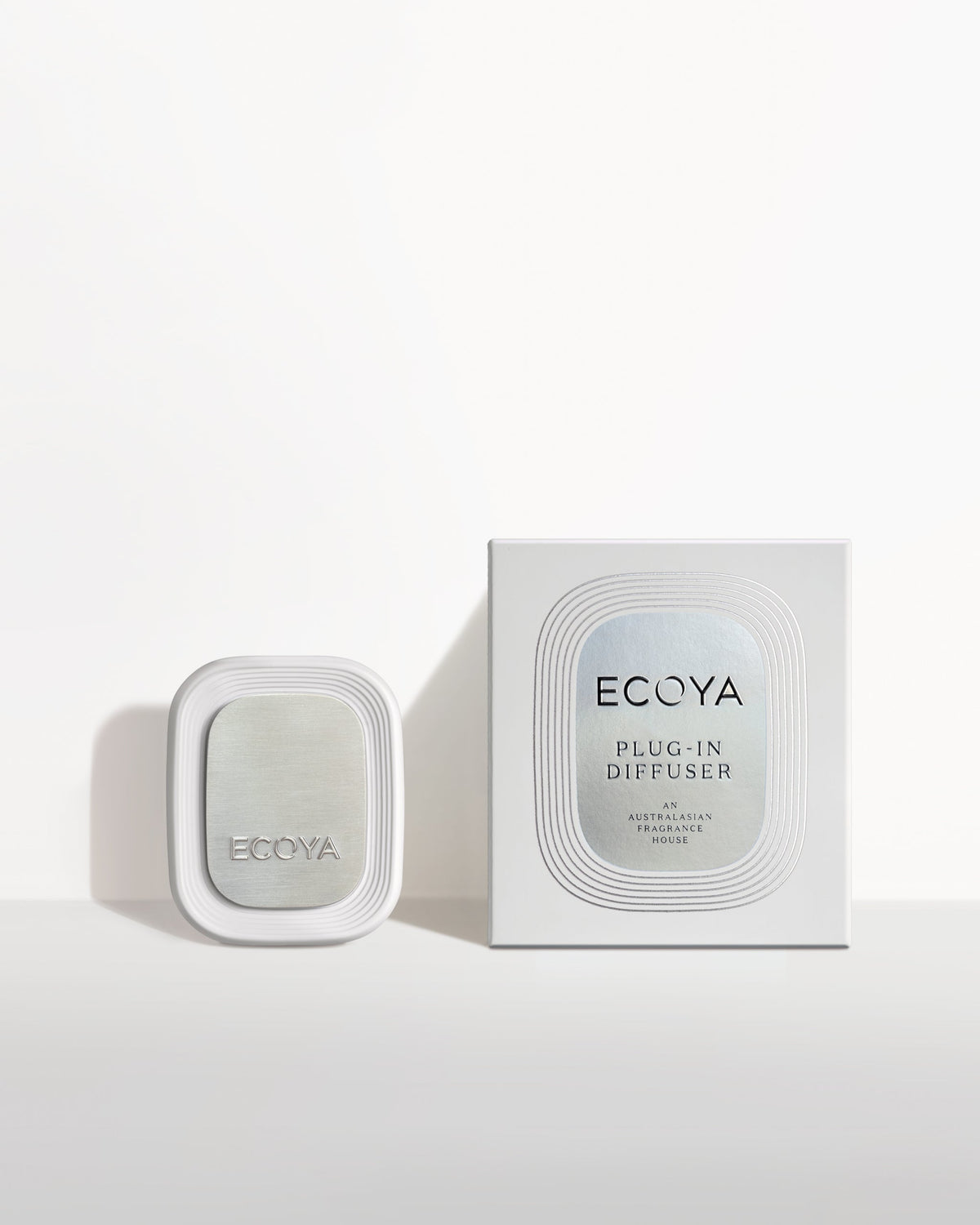 Ecoya Plug-In Diffuser beside its retail packaging on a white surface with soft shadows