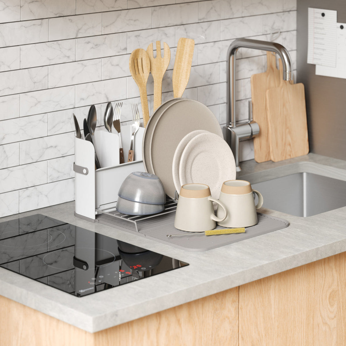 Umbra Sling dish rack on a kitchen bench beside the sink with dishes drying