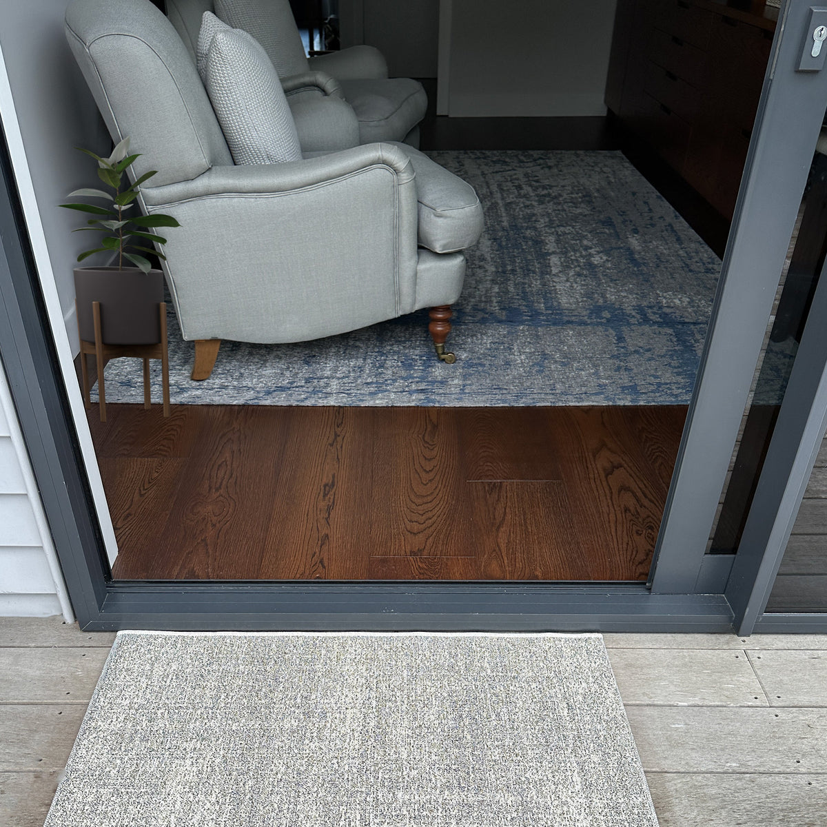 Rug shown in the 60 x 90 cm mat size outside open glass doors leading to a lounge