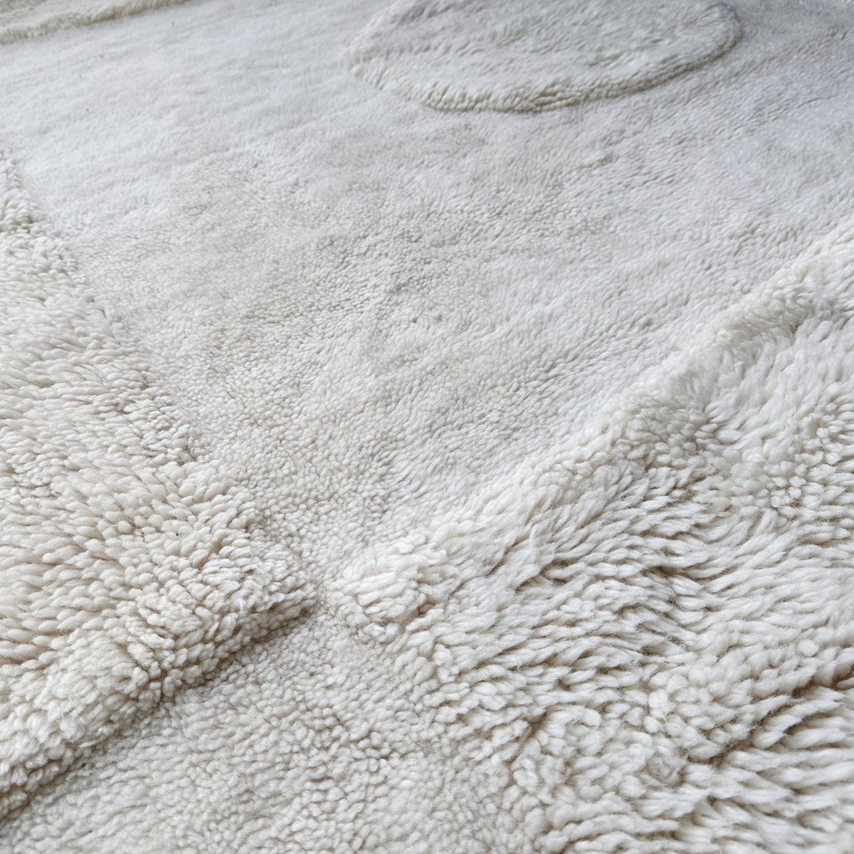 Close view of the carved high and low ivory wool pile