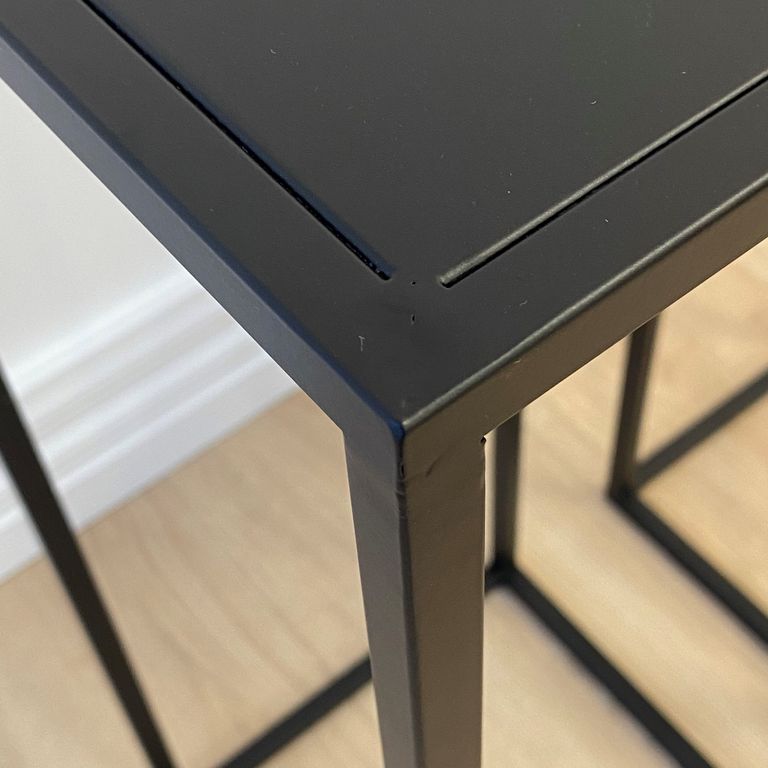 Close view of a plinth's top corner, showing the flat panel set inside the welded frame