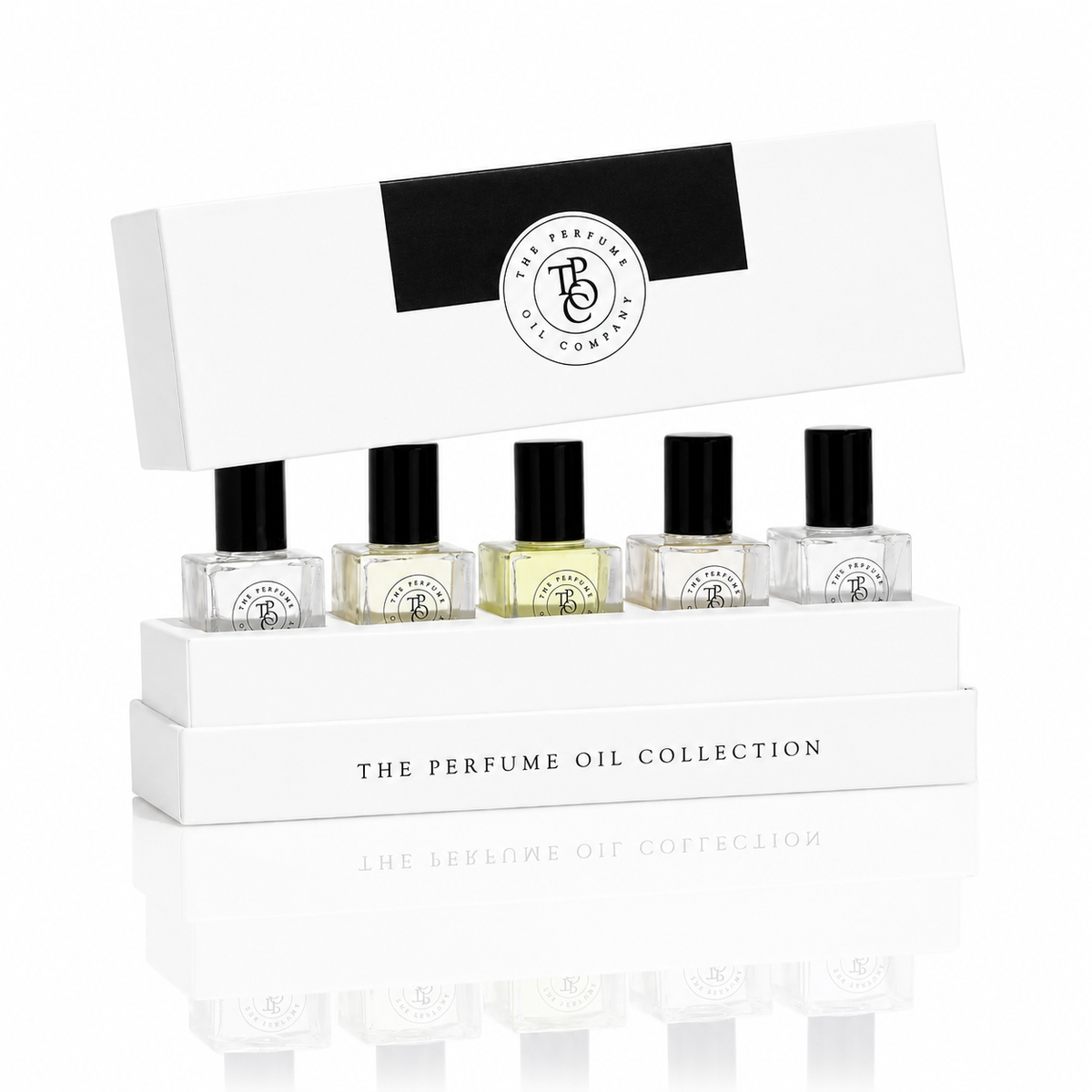 The Perfume Oil Company presentation box holding five roll-on perfume oil bottles, with the lid propped behind