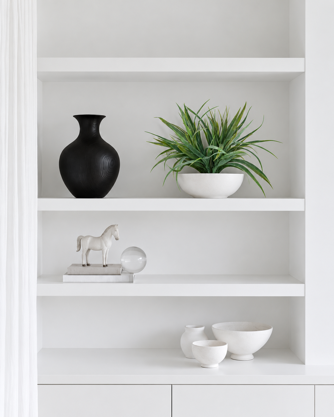 Ryegrass bush on the middle shelf of white built-in shelving