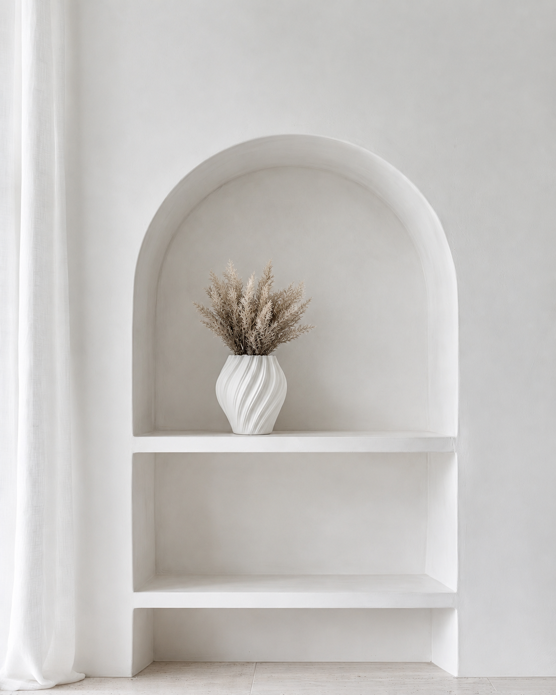 Astilbe Bundle in Mocha in a small white ribbed ceramic vase on the middle shelf of the arched wall niche