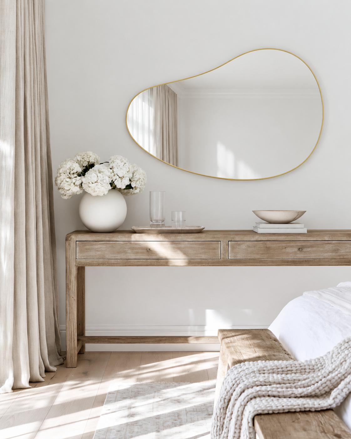 Brass Hubba Pebble mirror above the bleached elm console