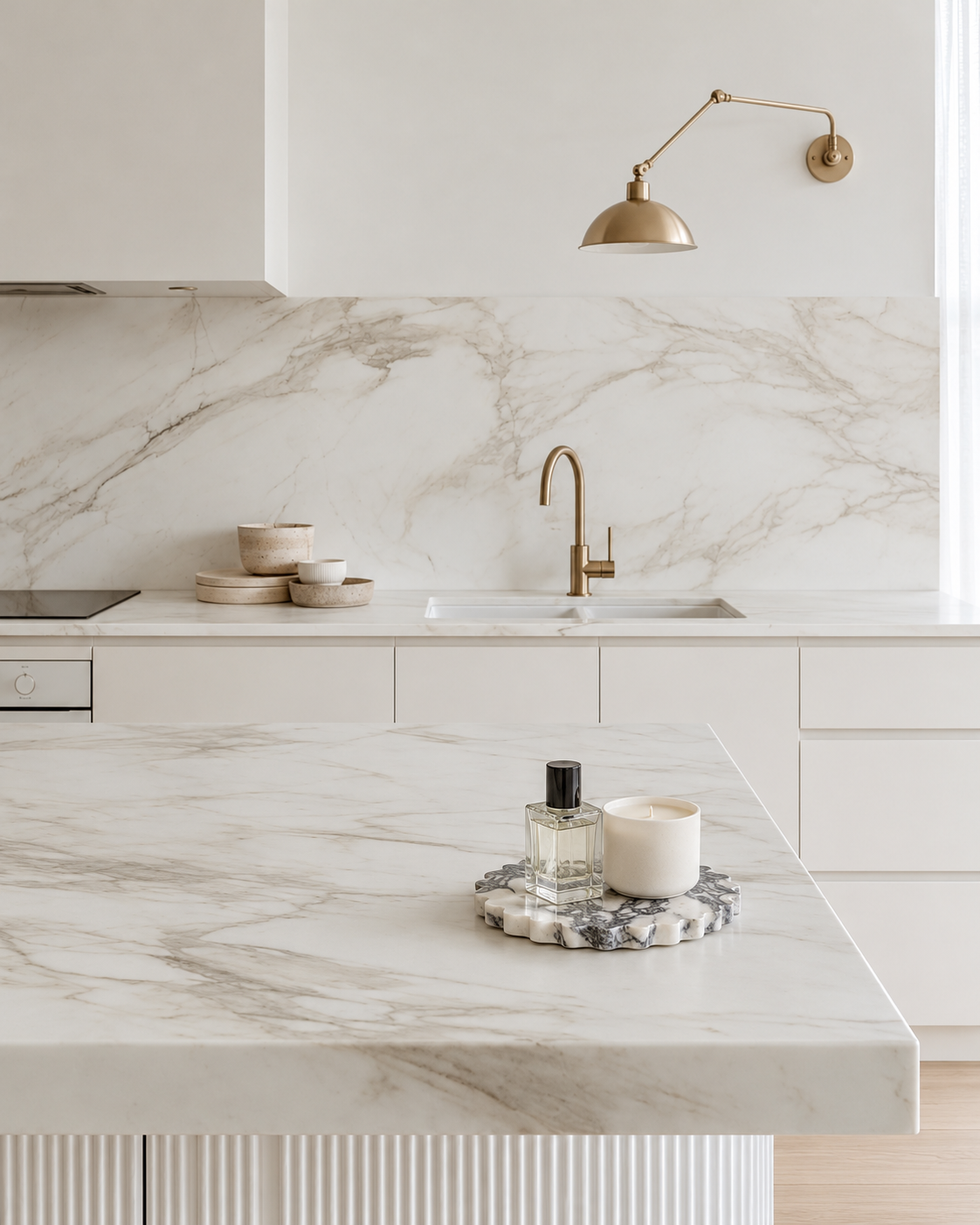 Elle Petal-Edge Marble Tray on the marble island beside the brass sconce