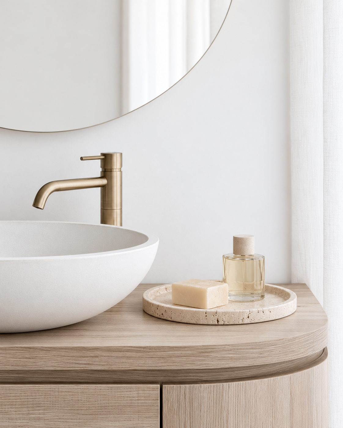 Moon Round Travertine Tray on the timber vanity beside the basin, holding a bar of soap and a small glass bottle