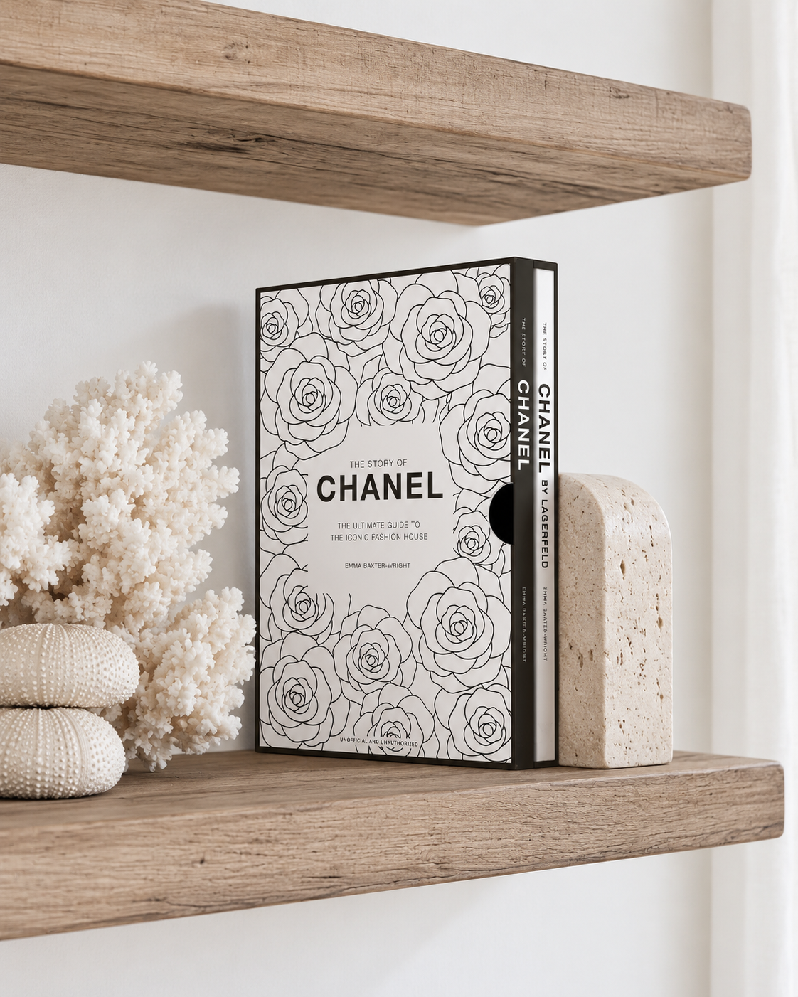 The Story of Chanel gift set standing on a timber shelf against a travertine bookend