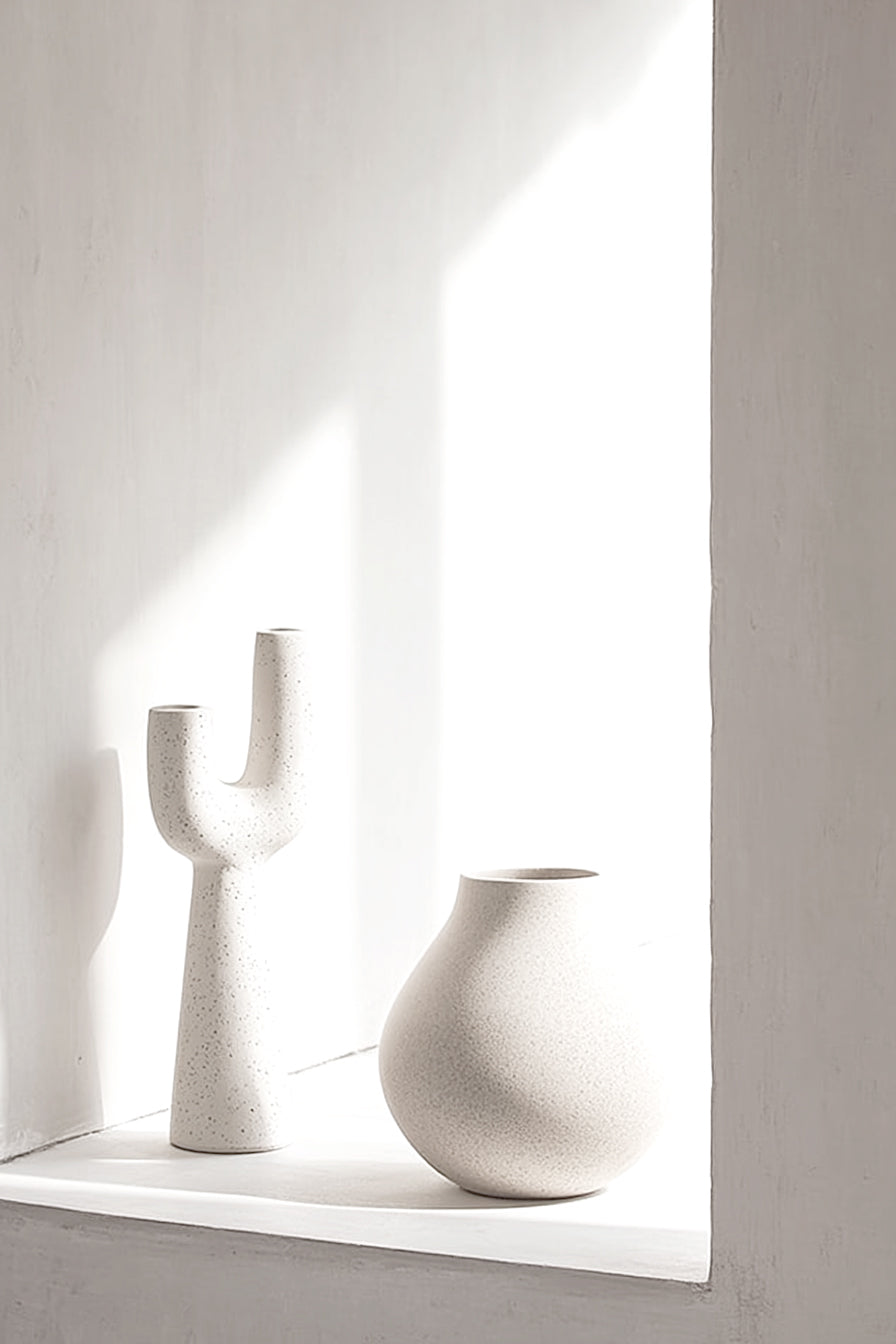 Franki vase on a sunlit white window ledge beside a round vase