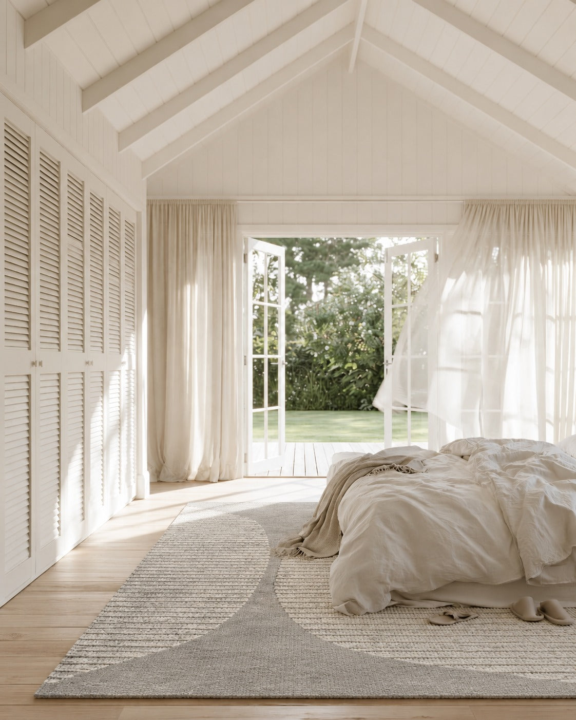 Habitat Curve Natural Rug beside a linen dressed bed in a white bedroom with louvre wardrobe doors