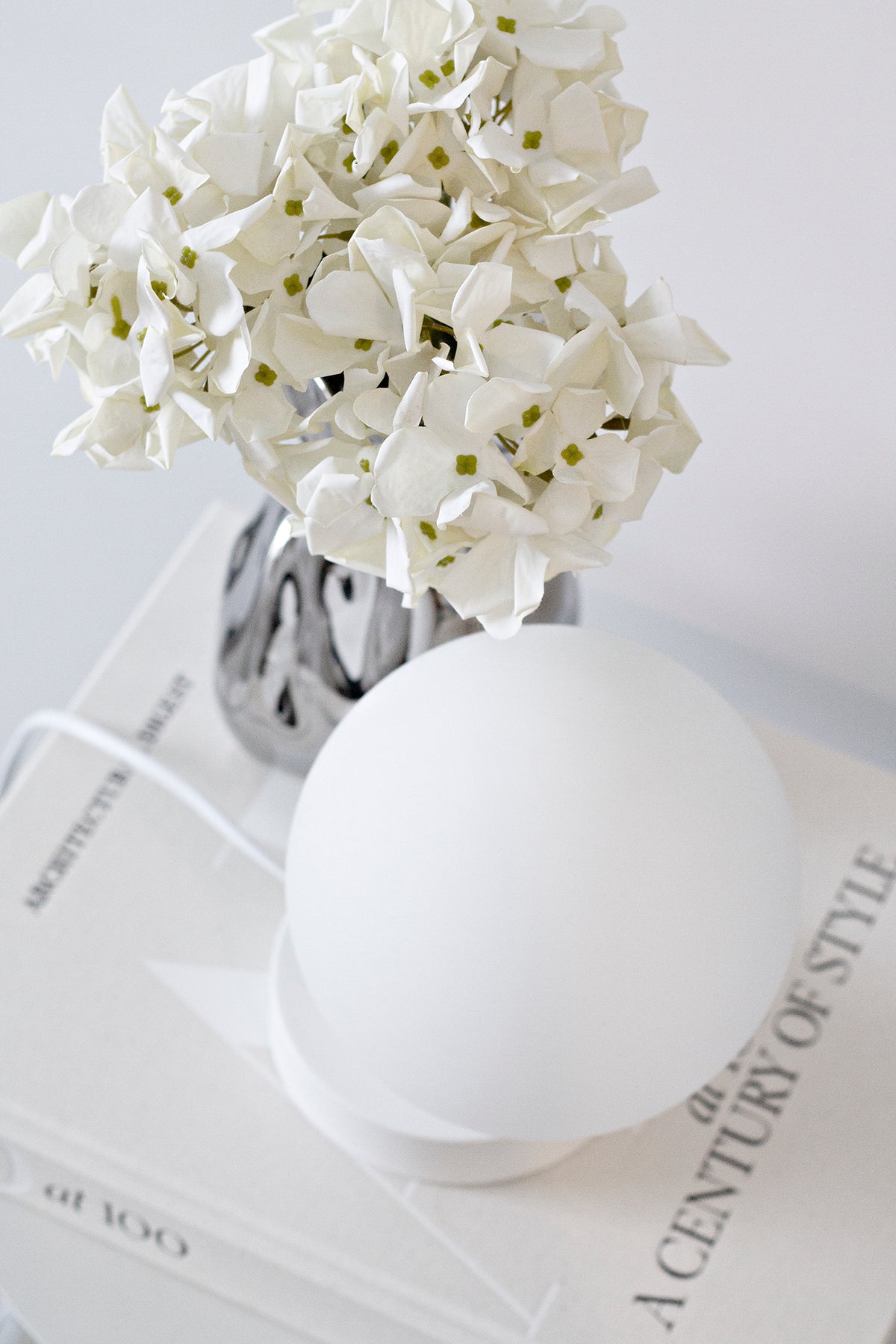 Petite faux hydrangea stem styled in a bud vase