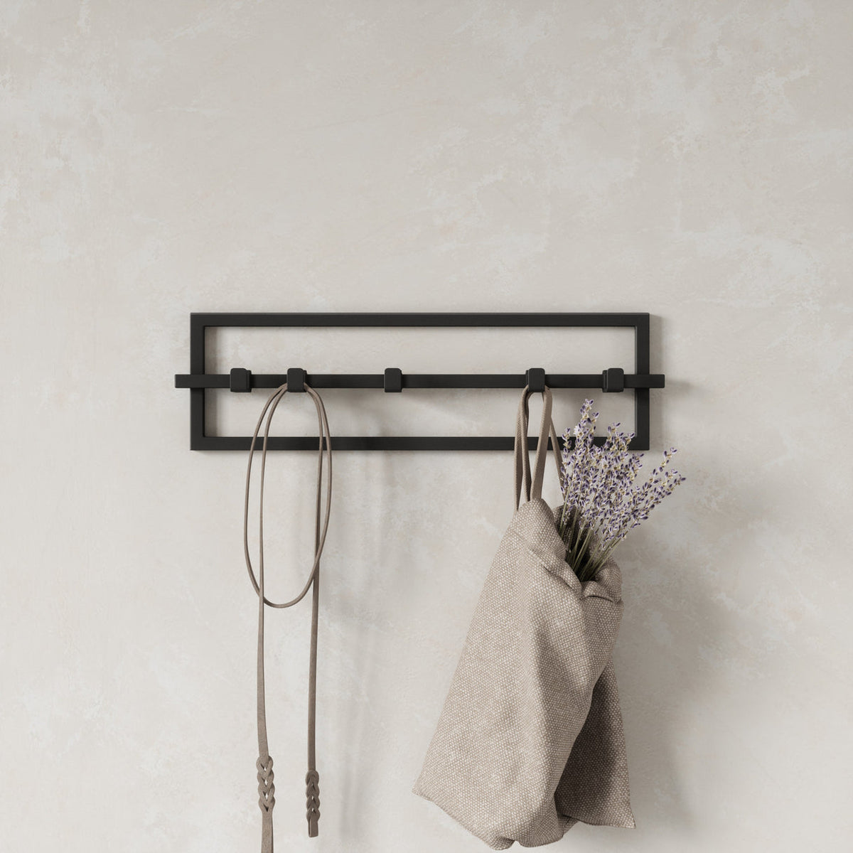Umbra Cubiko 5 hook wall rack in black with a linen tote, keys and dried flowers hanging