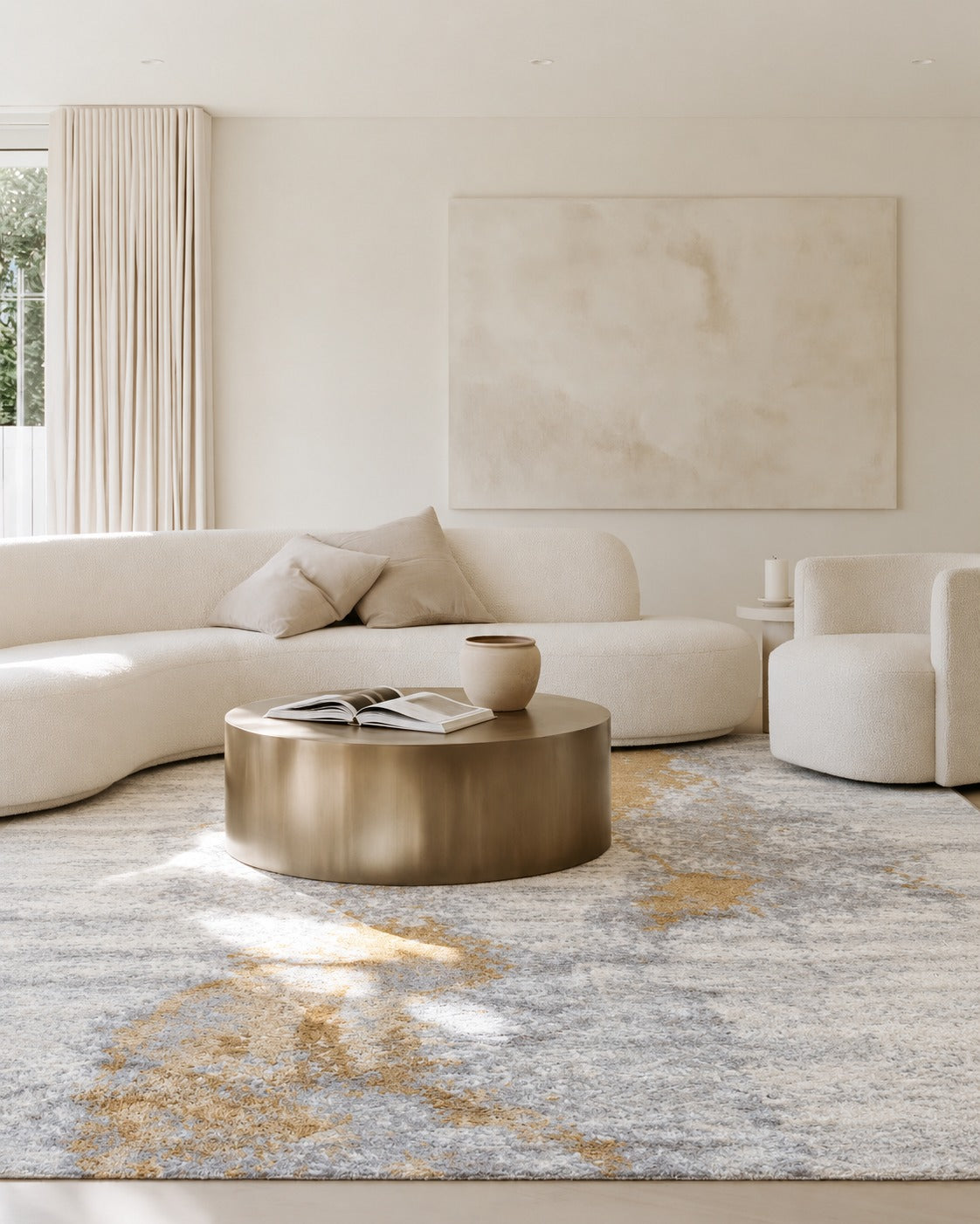 Laine Gold Lustre Rug under a round brass coffee table in a cream lounge with a curved boucle sofa