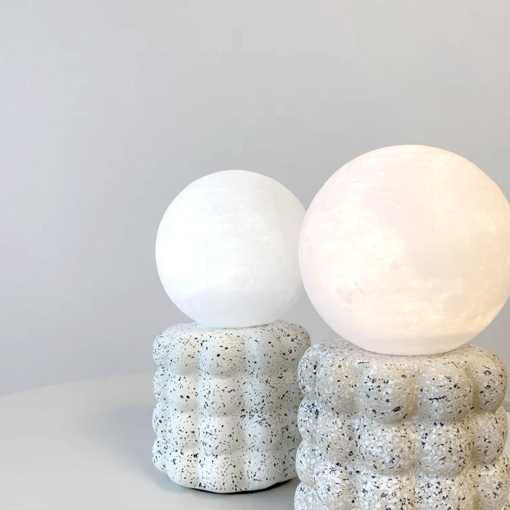 Two Elara Glow lamps side by side, one unlit and one glowing warm white