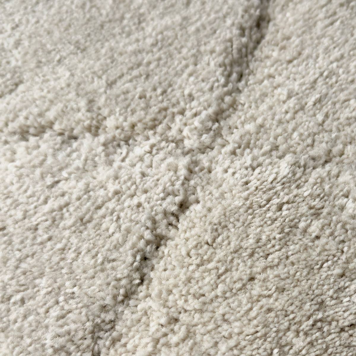 Close view of the soft white pile with a carved line running through it