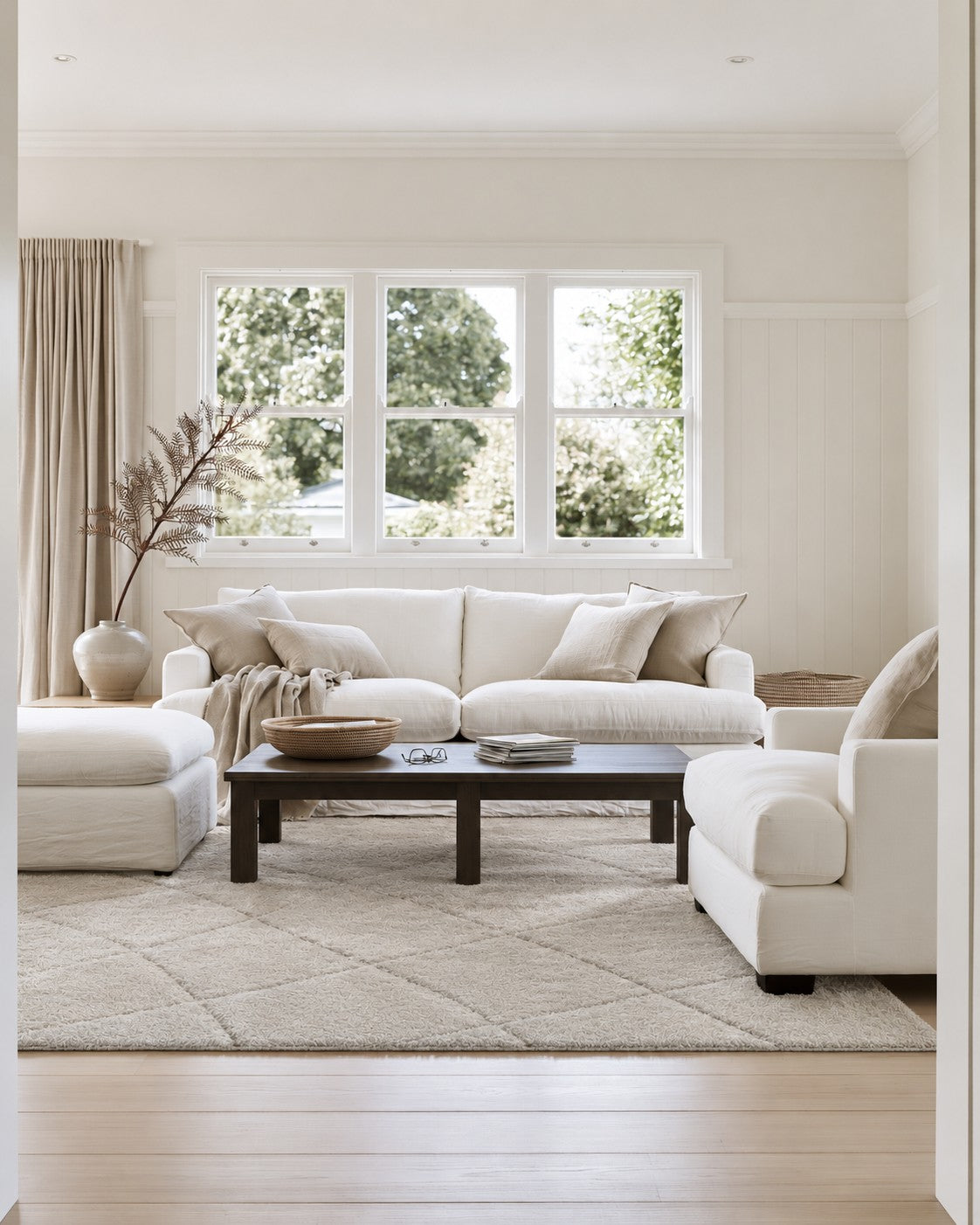 Lowry Etched White Rug styled in a villa lounge beneath white sofas and a dark coffee table
