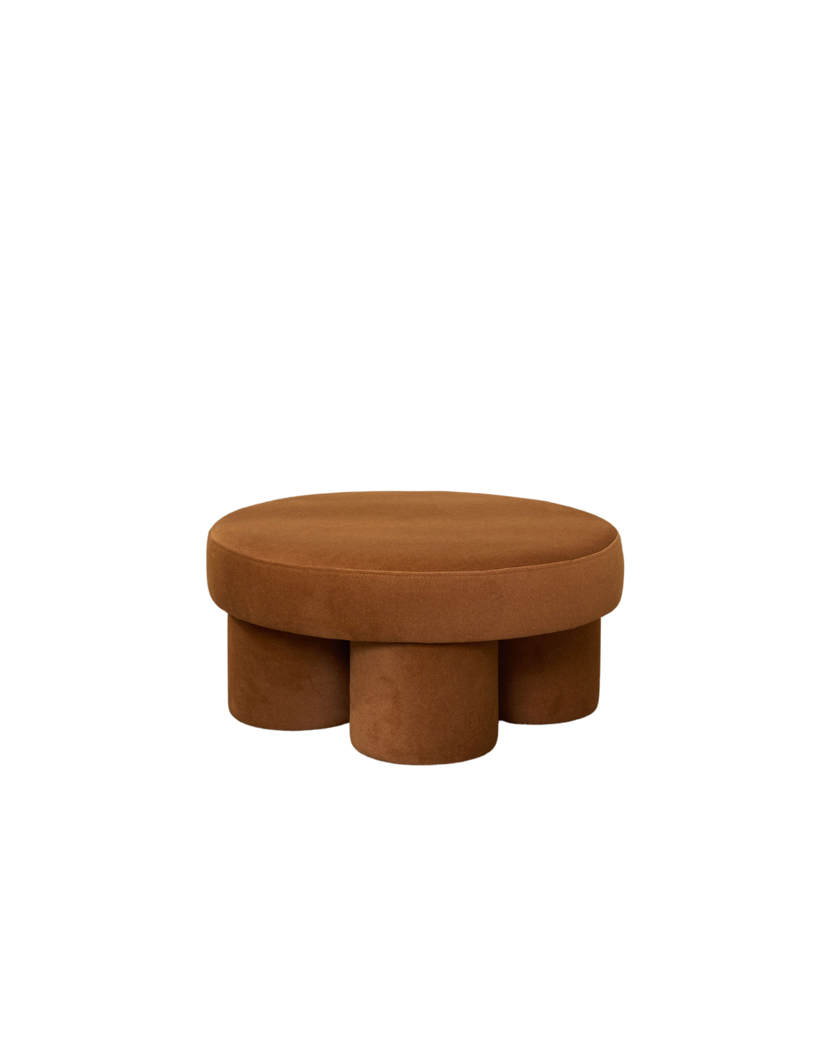 Lume Ottoman by Ned Collections in a caramel velvet-look finish on four round legs, on a white background