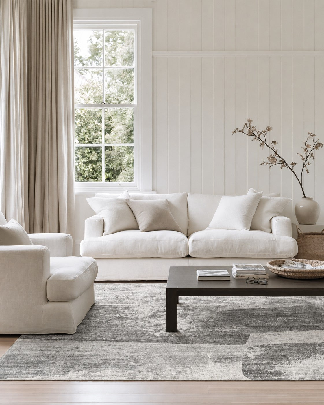 Malta Shadow Rug styled in a villa lounge beneath a white sofa and dark coffee table