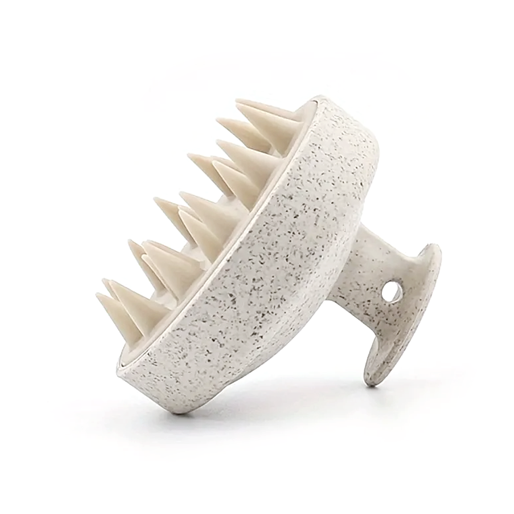 Three-quarter view of the speckled scalp massager showing the tapered bristles and looped grip