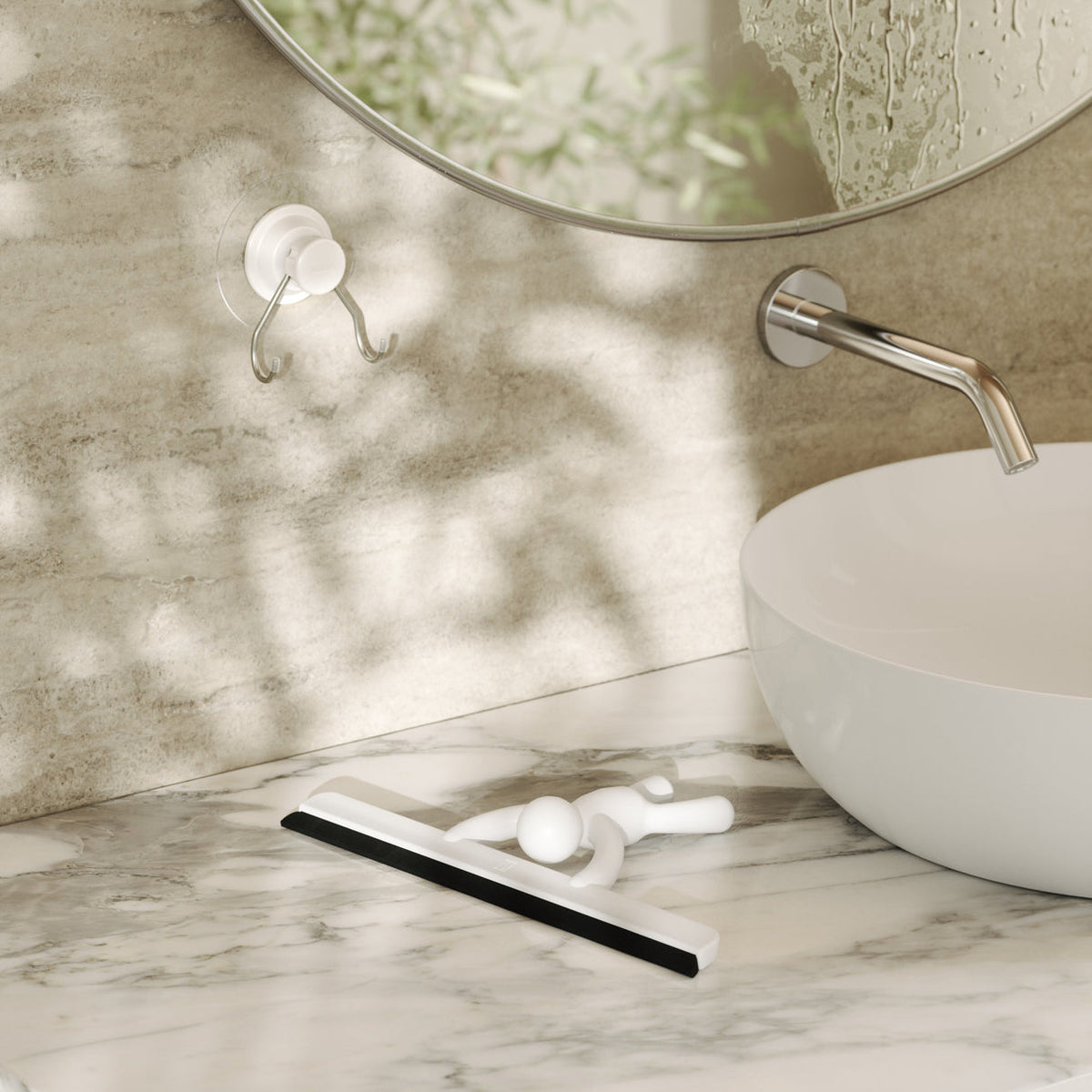 Umbra Buddy Squeegee styled on a minimalist bathroom counter alongside everyday bathroom essentials