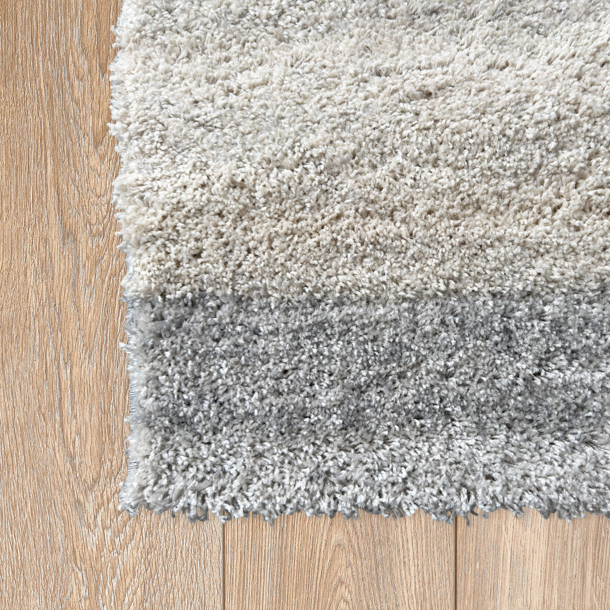 Corner of the cloud grey rug on a light timber floor