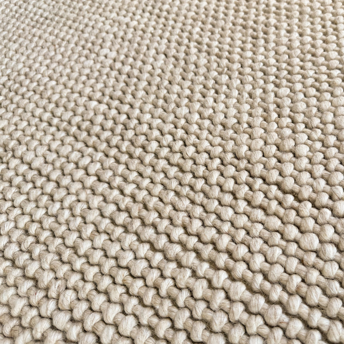 Close view of the chunky beige wool and cotton loops