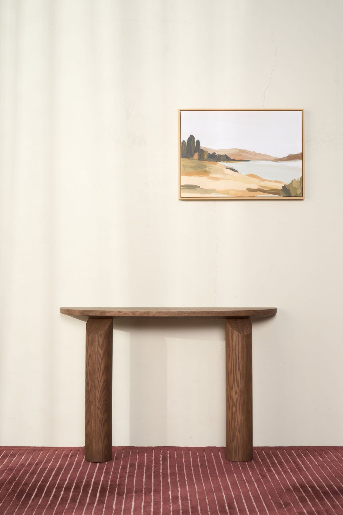 Brown Ash console against a cream wall with a framed landscape print above