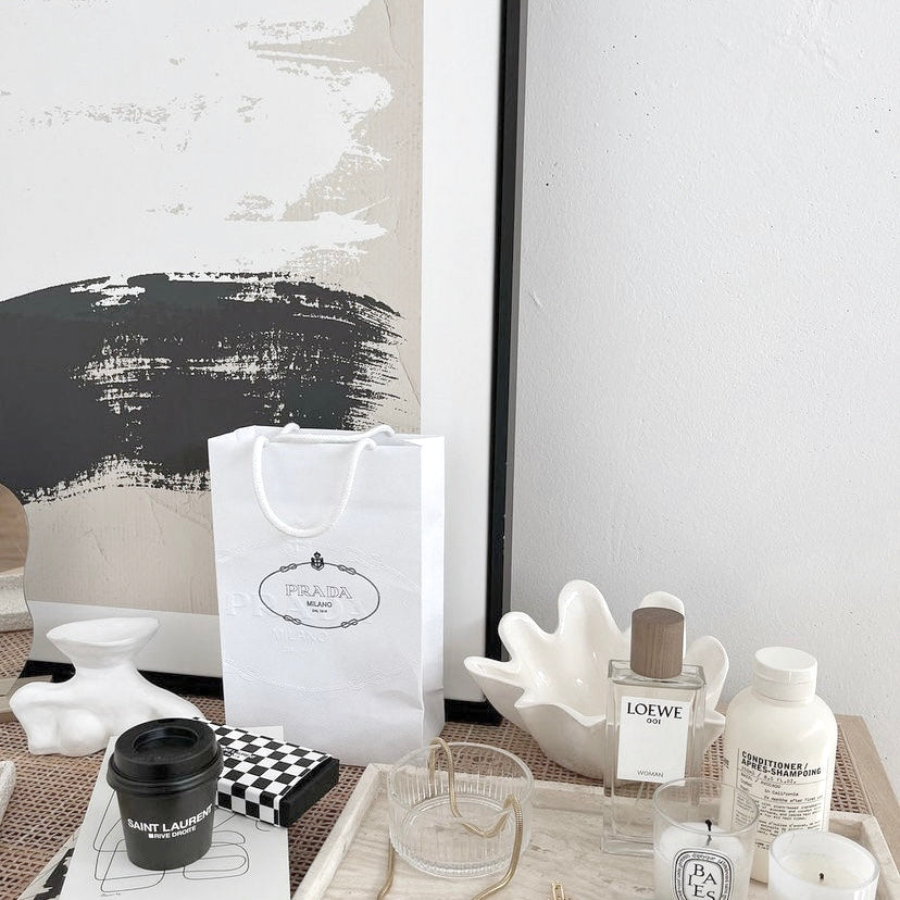 Close view of the Painted Canvas print in a black frame behind a styled desk of accessories