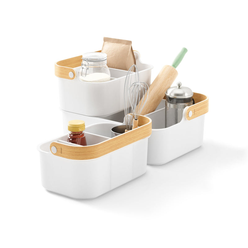 A white kitchen with Umbra stackable bins for organizing recycled plastic utensils, like the Bellwood Storage Bin.