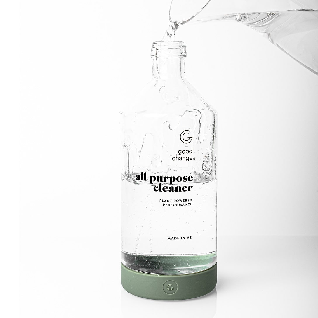 Water being poured into a Good Change reusable glass spray bottle.
